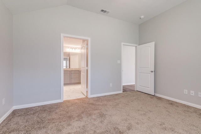 5520 Curzon Ave, Fort Worth, TX 76107 - unfurnished bedroom featuring light colored carpet, lofted ceiling, baseboards, and ensuite bath