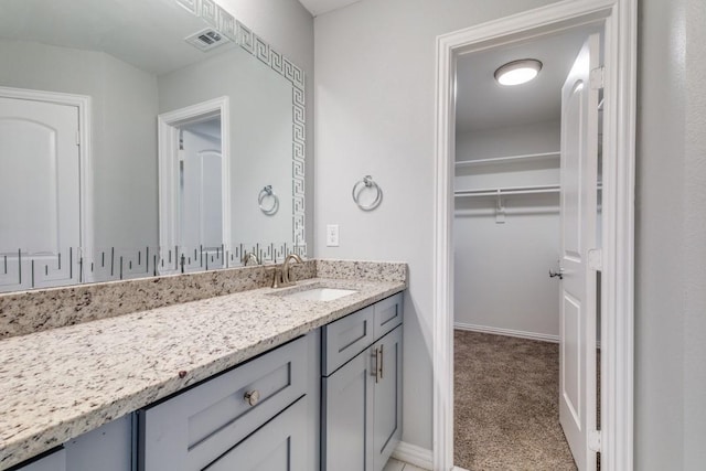 5520 Curzon Ave, Fort Worth, TX 76107 - bathroom with vanity, a walk in closet, and baseboards