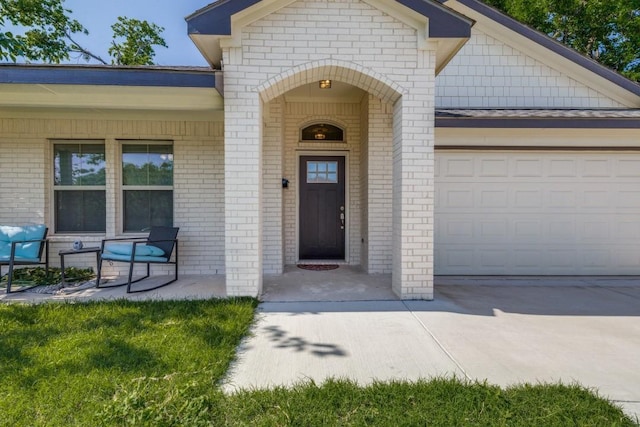 5520 Curzon Ave, Fort Worth, TX 76107 - view of exterior entry with brick siding, covered porch, and a garage