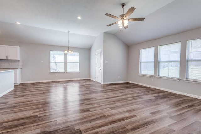 5520 Curzon Ave, Fort Worth, TX 76107 - unfurnished living room with a chandelier, lofted ceiling, wood finished floors, a ceiling fan, and baseboards