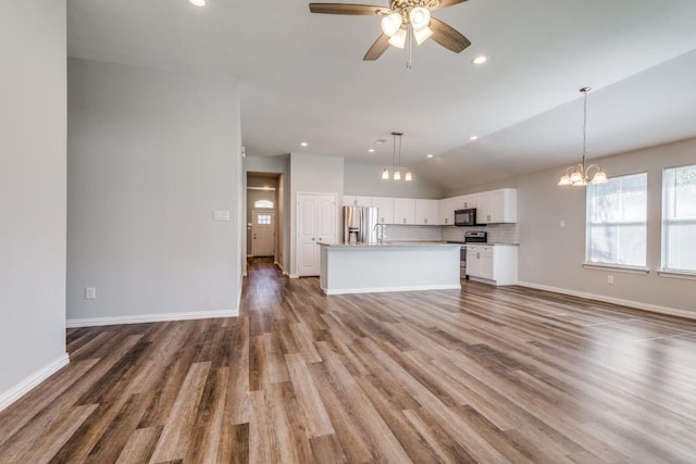 5520 Curzon Ave, Fort Worth, TX 76107 - unfurnished living room featuring vaulted ceiling, ceiling fan, a chandelier, wood finished floors, and recessed lighting