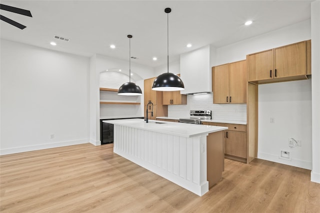 2820 Barnes Bridge Rd, Dallas, TX 75228 - kitchen featuring stainless steel electric range oven, decorative backsplash, light countertops, a sink, and a kitchen island with sink