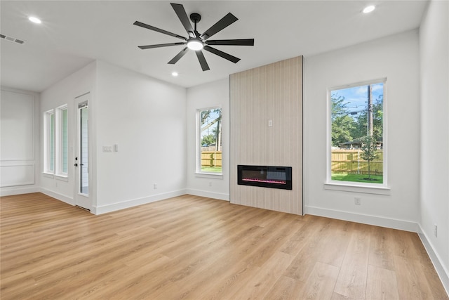 2820 Barnes Bridge Rd, Dallas, TX 75228 - unfurnished living room featuring light wood finished floors, a large fireplace, recessed lighting, heating unit, and baseboards