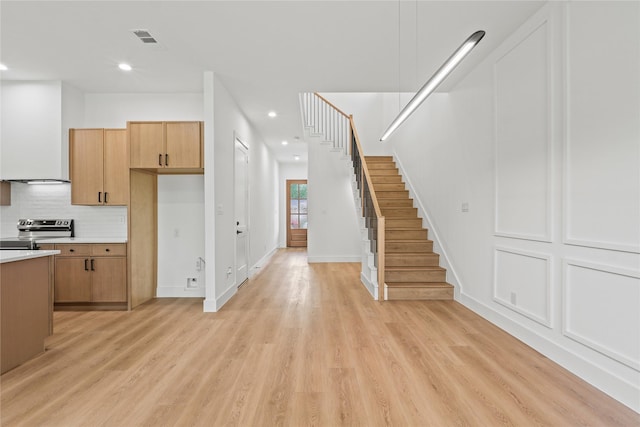2820 Barnes Bridge Rd, Dallas, TX 75228 - kitchen with electric range, light wood finished floors, light countertops, recessed lighting, and decorative backsplash