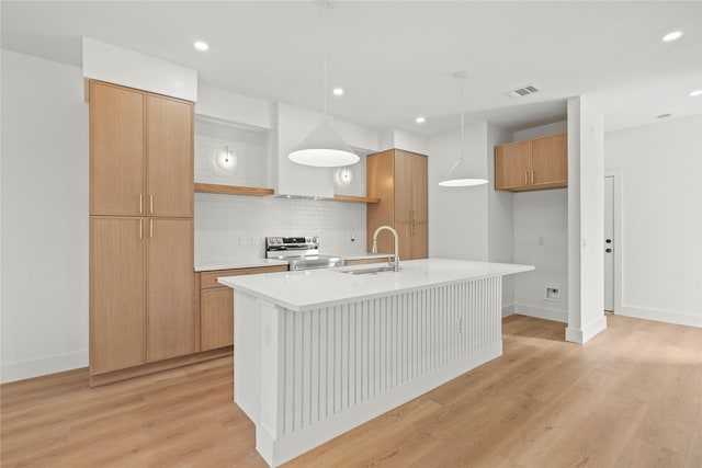 1332 Fletcher St, Dallas, TX 75223 - kitchen with electric range, a sink, a center island with sink, tasteful backsplash, and light wood-style flooring