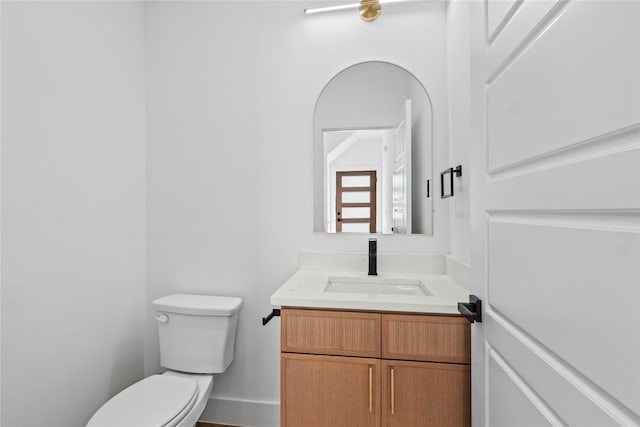 1332 Fletcher St, Dallas, TX 75223 - half bathroom featuring toilet, vanity, and baseboards