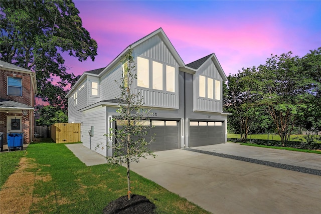 1332 Fletcher St, Dallas, TX 75223 - view of front of house featuring concrete driveway, an attached garage, and board and batten siding