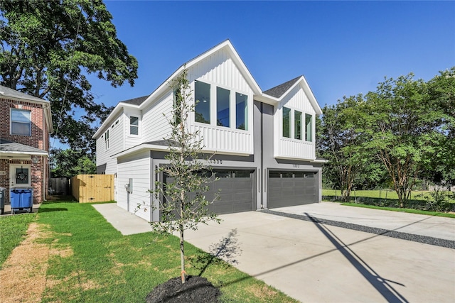 1332 Fletcher St, Dallas, TX 75223 - view of front of property featuring board and batten siding, a garage, and driveway
