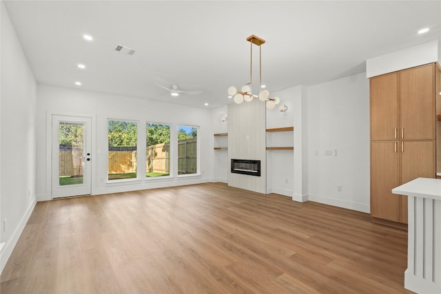 1332 Fletcher St, Dallas, TX 75223 - unfurnished living room with recessed lighting, light wood-style flooring, heating unit, a glass covered fireplace, and baseboards