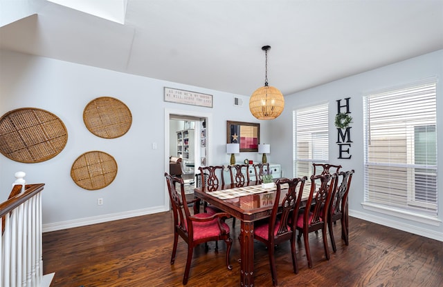 1015 W Bluff St, Fort Worth, TX 76102 - dining area featuring wood finished floors, a chandelier, and baseboards