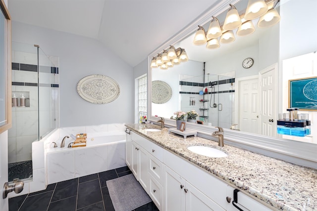 1015 W Bluff St, Fort Worth, TX 76102 - bathroom with vaulted ceiling, a garden tub, a stall shower, double vanity, and tile patterned floors