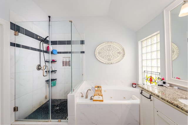 1015 W Bluff St, Fort Worth, TX 76102 - bathroom with a tub with jets, a shower stall, vanity, and vaulted ceiling