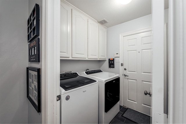 1015 W Bluff St, Fort Worth, TX 76102 - laundry room featuring cabinet space, washing machine and dryer, and dark tile patterned floors