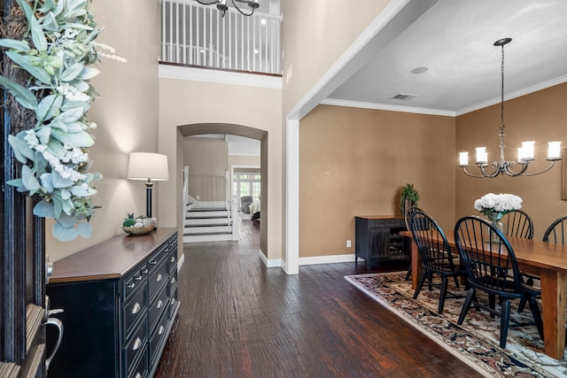 8920 Cypress Creek Rd, Lantana, TX 76226 - dining space featuring a chandelier, arched walkways, dark wood finished floors, baseboards, and crown molding