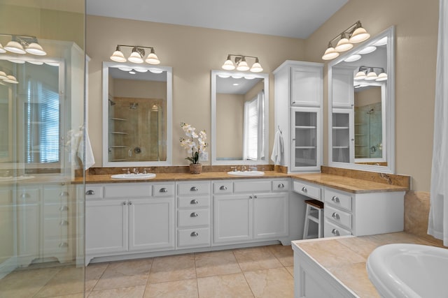 8920 Cypress Creek Rd, Lantana, TX 76226 - bathroom featuring double vanity, a shower with shower door, and tile patterned floors