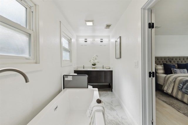 4104 Middlebrook Rd, Fort Worth, TX 76116 - bathroom with ensuite bath, double vanity, a bath, marble look tile flooring, and baseboards