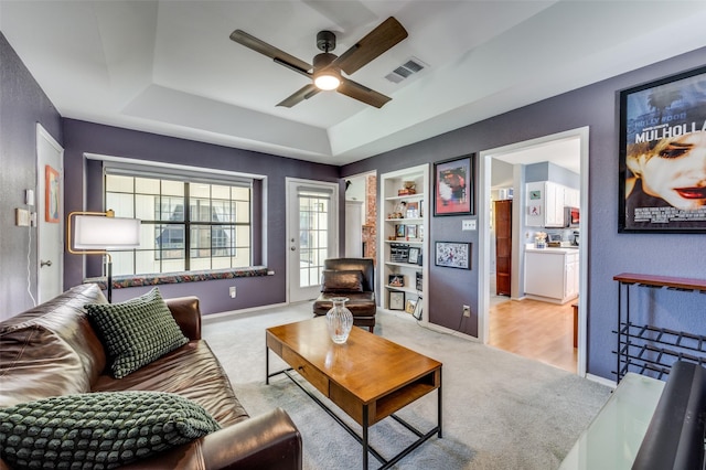 4500 Keys Dr, The Colony, TX 75056 - carpeted living room featuring a tray ceiling, ceiling fan, and baseboards