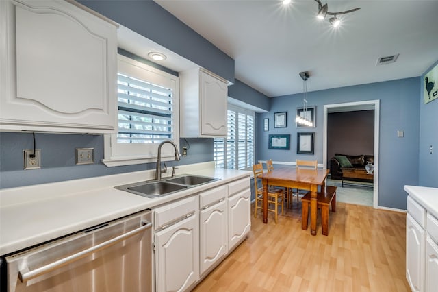 4500 Keys Dr, The Colony, TX 75056 - kitchen with stainless steel dishwasher, a sink, white cabinets, light wood-type flooring, and light countertops