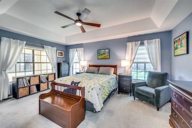 4500 Keys Dr, The Colony, TX 75056 - bedroom featuring a raised ceiling, light carpet, and a ceiling fan