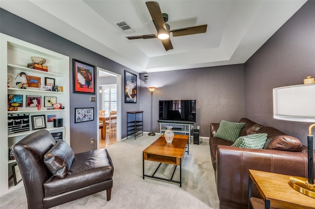 4500 Keys Dr, The Colony, TX 75056 - living room with a ceiling fan, carpet floors, a raised ceiling, and built in shelves