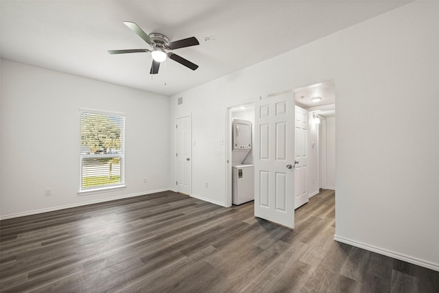 11218 Park Central Pl Unit B, Dallas, TX 75230 - unfurnished bedroom featuring estacked washer and dryer, dark wood-style floors, baseboards, and a ceiling fan