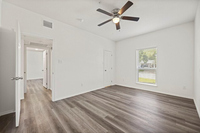 11218 Park Central Pl Unit B, Dallas, TX 75230 - unfurnished room with wood finished floors, ceiling fan, and baseboards