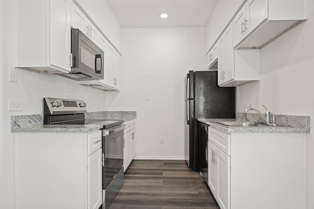 11218 Park Central Pl Unit B, Dallas, TX 75230 - kitchen with stainless steel electric range oven, black microwave, a sink, dark wood finished floors, and light countertops