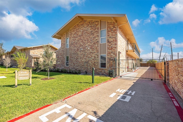 11218 Park Central Pl Unit B, Dallas, TX 75230 - view of side of home featuring a gate, brick siding, and central AC