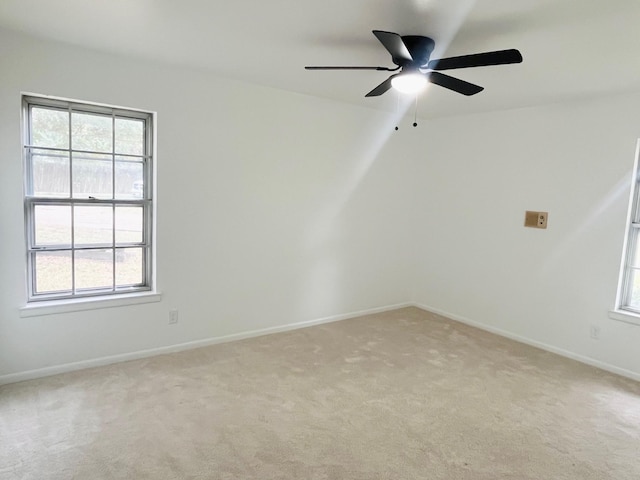 1707 Williamsburg Cir, Ennis, TX 75119 - unfurnished room featuring light colored carpet, plenty of natural light, and ceiling fan