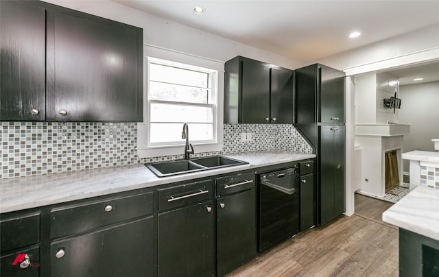 9472 Ranch Ln, Shreveport, LA 71106 - kitchen featuring a sink, dishwasher, light wood-type flooring, backsplash, and a fireplace
