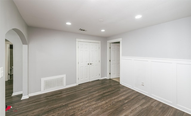 9472 Ranch Ln, Shreveport, LA 71106 - spare room featuring wood finished floors, arched walkways, a wainscoted wall, and recessed lighting