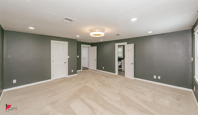 9472 Ranch Ln, Shreveport, LA 71106 - unfurnished bedroom featuring light colored carpet, baseboards, recessed lighting, and two closets