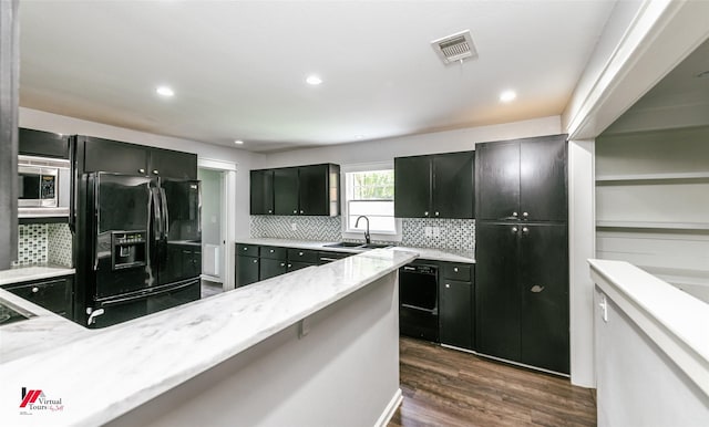 9472 Ranch Ln, Shreveport, LA 71106 - kitchen with a sink, black appliances, dark cabinetry, dark wood finished floors, and backsplash
