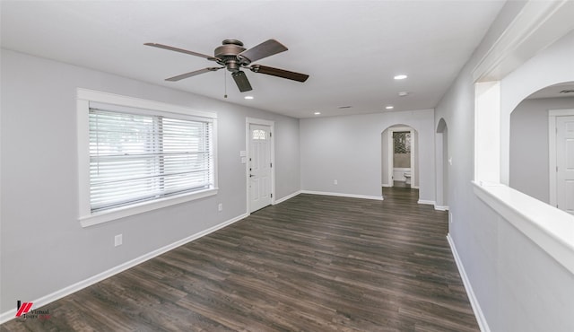 9472 Ranch Ln, Shreveport, LA 71106 - empty room with arched walkways, a ceiling fan, recessed lighting, dark wood finished floors, and baseboards