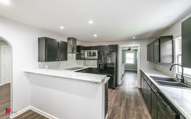9472 Ranch Ln, Shreveport, LA 71106 - kitchen featuring black appliances, wall chimney exhaust hood, a sink, a peninsula, and dark wood-style flooring