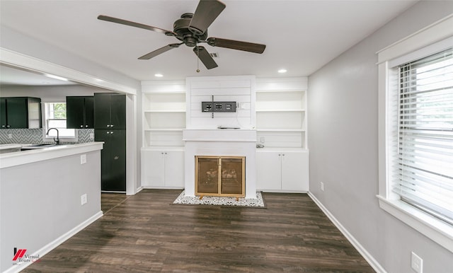 9472 Ranch Ln, Shreveport, LA 71106 - unfurnished living room featuring ceiling fan, dark wood-style floors, a fireplace, recessed lighting, and a sink