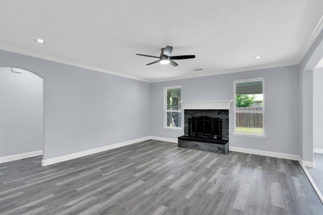 211 Debbie Way, Red Oak, TX 75154 - unfurnished living room featuring wood finished floors, a ceiling fan, baseboards, crown molding, and arched walkways