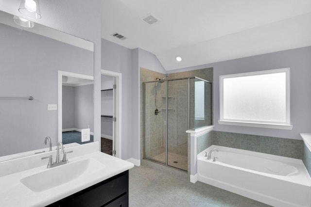 211 Debbie Way, Red Oak, TX 75154 - full bathroom with a stall shower, a bath, a spacious closet, vanity, and vaulted ceiling