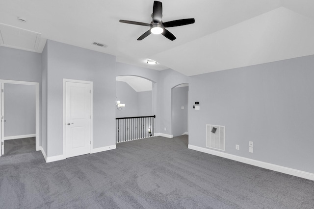 211 Debbie Way, Red Oak, TX 75154 - unfurnished room featuring ceiling fan, carpet floors, baseboards, attic access, and arched walkways