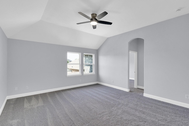 211 Debbie Way, Red Oak, TX 75154 - empty room featuring ceiling fan, arched walkways, dark carpet, lofted ceiling, and baseboards