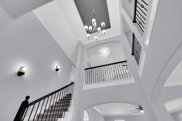 211 Debbie Way, Red Oak, TX 75154 - stairs with a high ceiling, a chandelier, a ceiling fan, ornamental molding, and arched walkways