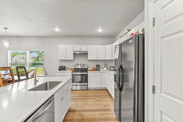 402 Robbins St, Cleburne, TX 76031 - kitchen with appliances with stainless steel finishes, a sink, under cabinet range hood, white cabinetry, and recessed lighting