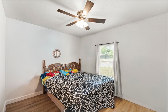 402 Robbins St, Cleburne, TX 76031 - bedroom with wood finished floors, baseboards, and a ceiling fan