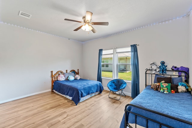 402 Robbins St, Cleburne, TX 76031 - bedroom with wood finished floors, baseboards, and ceiling fan