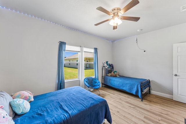 402 Robbins St, Cleburne, TX 76031 - bedroom with light wood-style floors, baseboards, and a ceiling fan