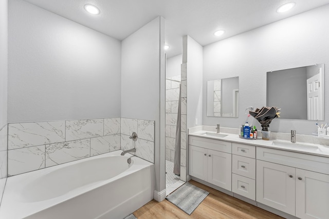 402 Robbins St, Cleburne, TX 76031 - full bath with double vanity, a garden tub, wood finished floors, and recessed lighting