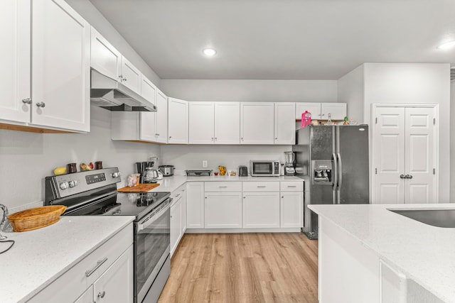 402 Robbins St, Cleburne, TX 76031 - kitchen with stainless steel appliances, under cabinet range hood, light wood finished floors, white cabinetry, and recessed lighting