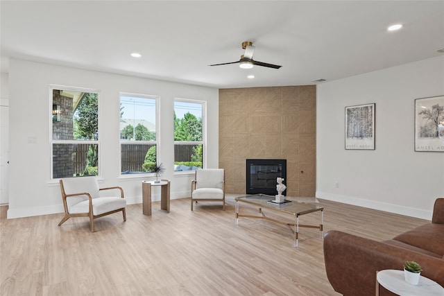 3717 Estacado Ln, Plano, TX 75025 - living area featuring light wood finished floors, a ceiling fan, recessed lighting, a tiled fireplace, and baseboards