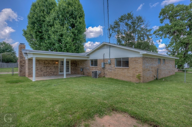 3422 Lanell Dr, Bossier City, LA 71112 - rear view of house featuring brick siding, a patio area, a chimney, and french doors