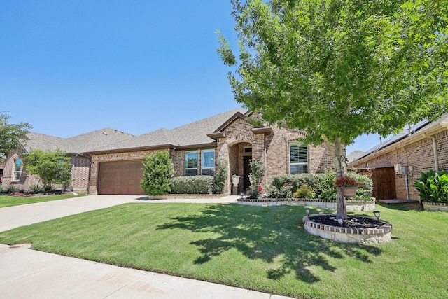 1816 Dunstan Dr, Fort Worth, TX 76052 - view of front of property with brick siding, an attached garage, a front yard, concrete driveway, and a shingled roof